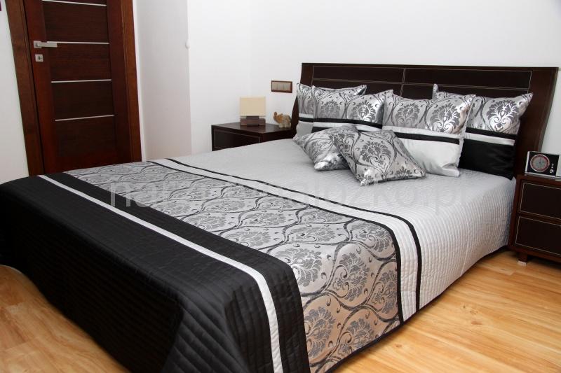 Elegancka narzuta na łóżko w kolorze szaro czarnym ze srebnym ornamentem
